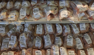 Shelves of poultry meat marked for sale.