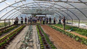 Touring one of several high tunnels at Granite Springs Farm with farmer Meredith Leight.